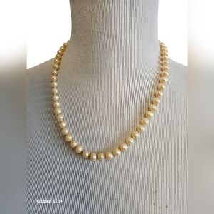 Vintage Faux pearl necklace with older silver tone clasp.